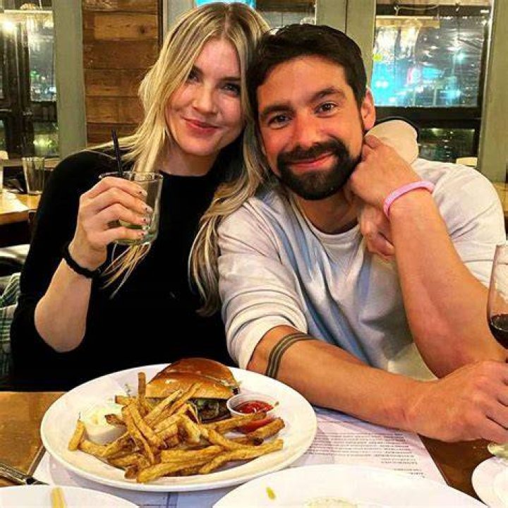 Amanda Kloots and Michael Allio pictured during a dinner while in arms.