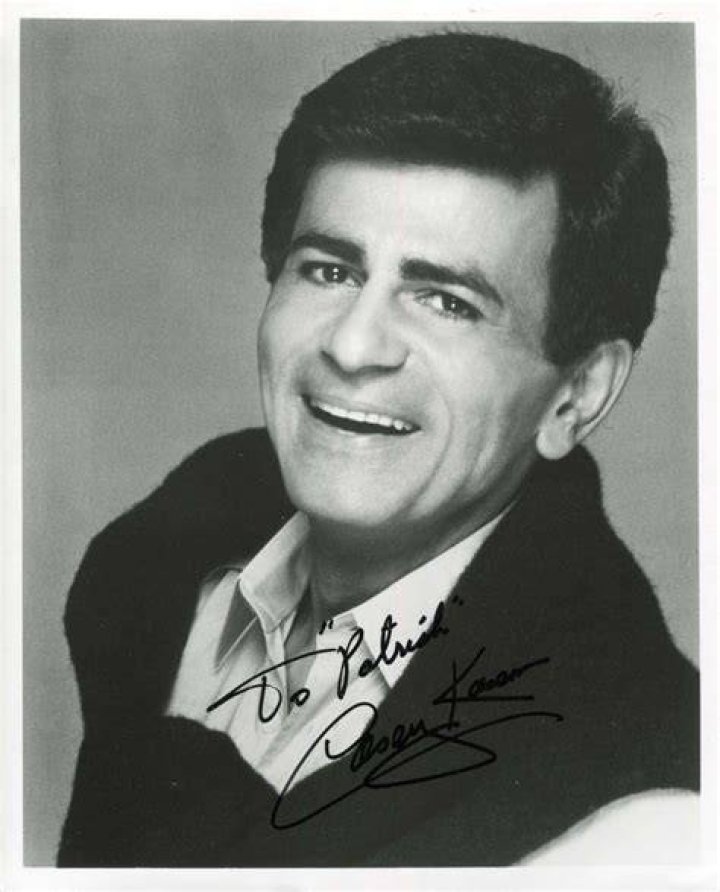 Casey Kasem is on a tuxedo whereas, Jean Kasem is wearing a pink dress with flowers on it.