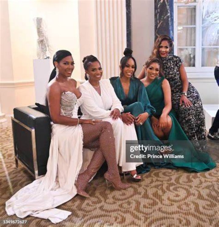 Drew Sidora and Kandi Burruss of Real Housewives of Atlanta sitting in chairs posing for the photo.