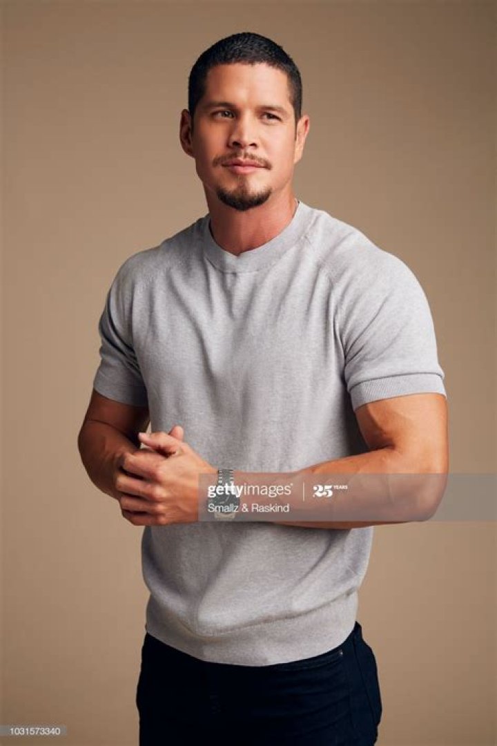JD Pardo is posing on a black sleeveless leather jacket in the picture.